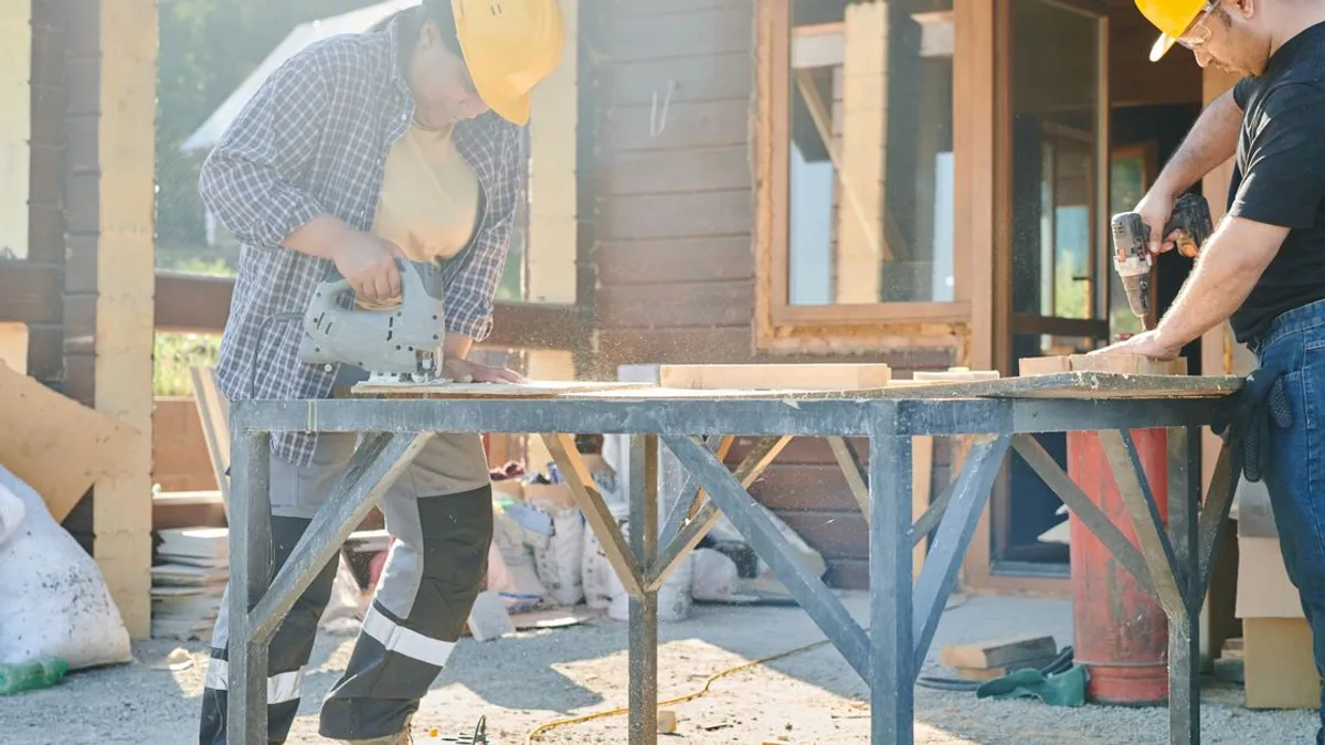 A tradesperson on site cutting timber with a circular saw